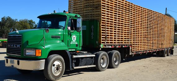 Green Mack truck pallet delivery