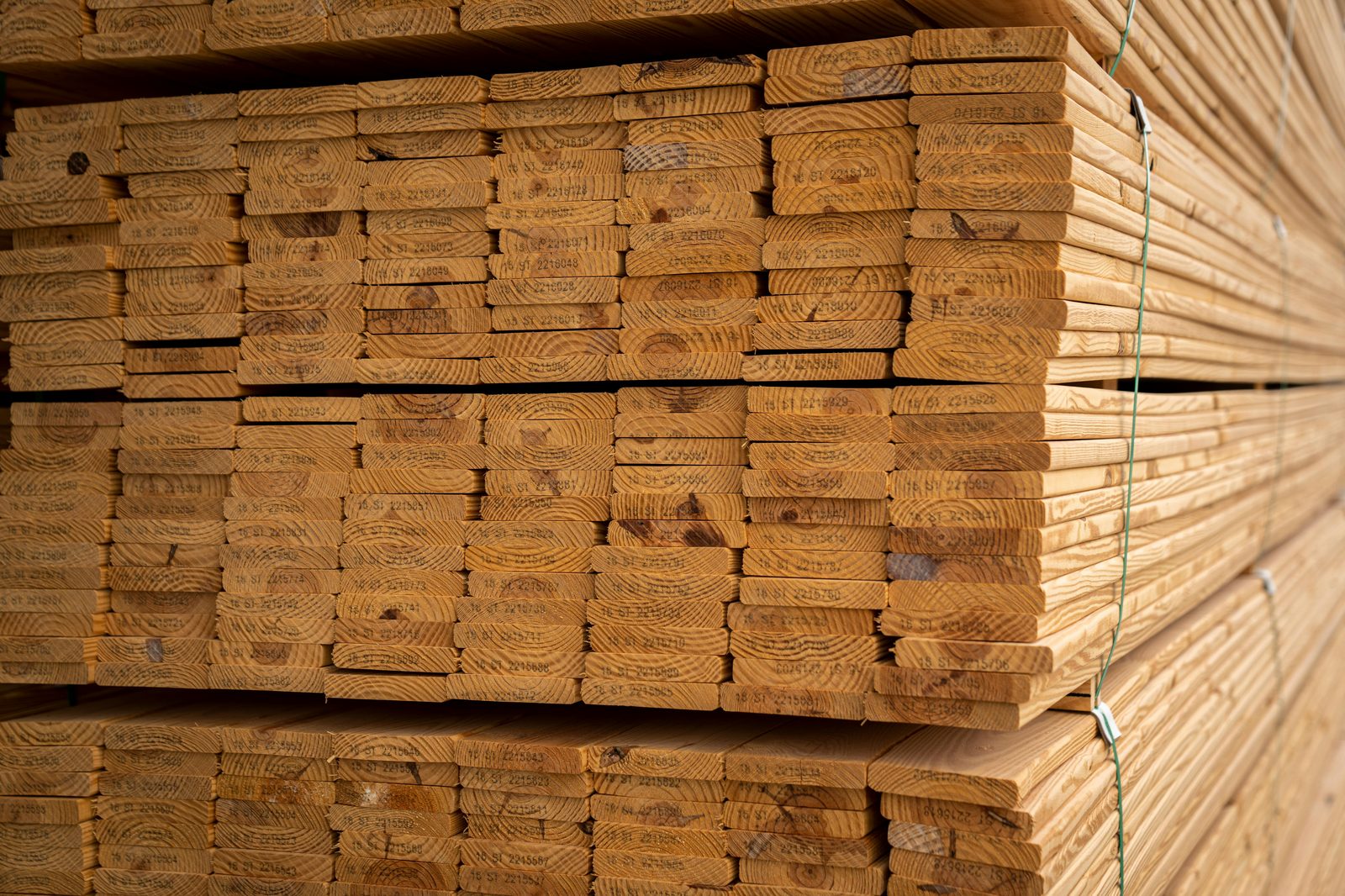 Kiln-dried stamped pallet lumber boards in stack at sawmill