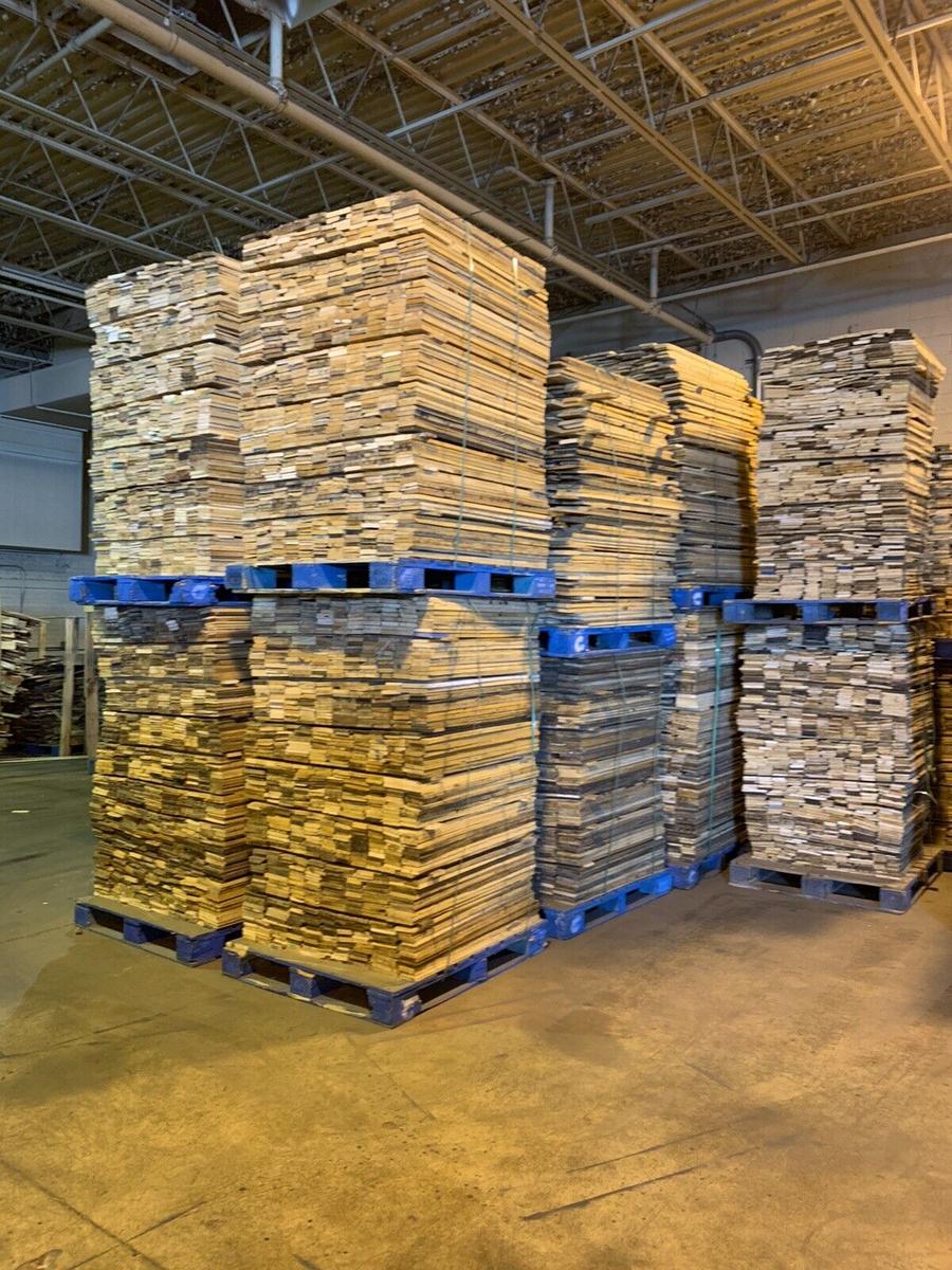 Lumber boards in warehouse for custom sod farm pallet manufacturing Florida