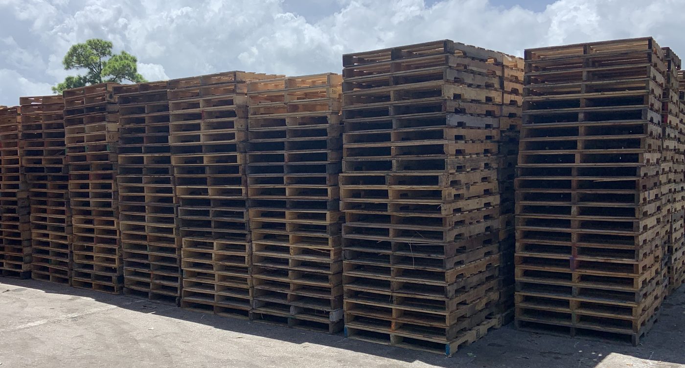 Large inventory of recycled GMA 48x40 pallets at Florida pallet supplier yard