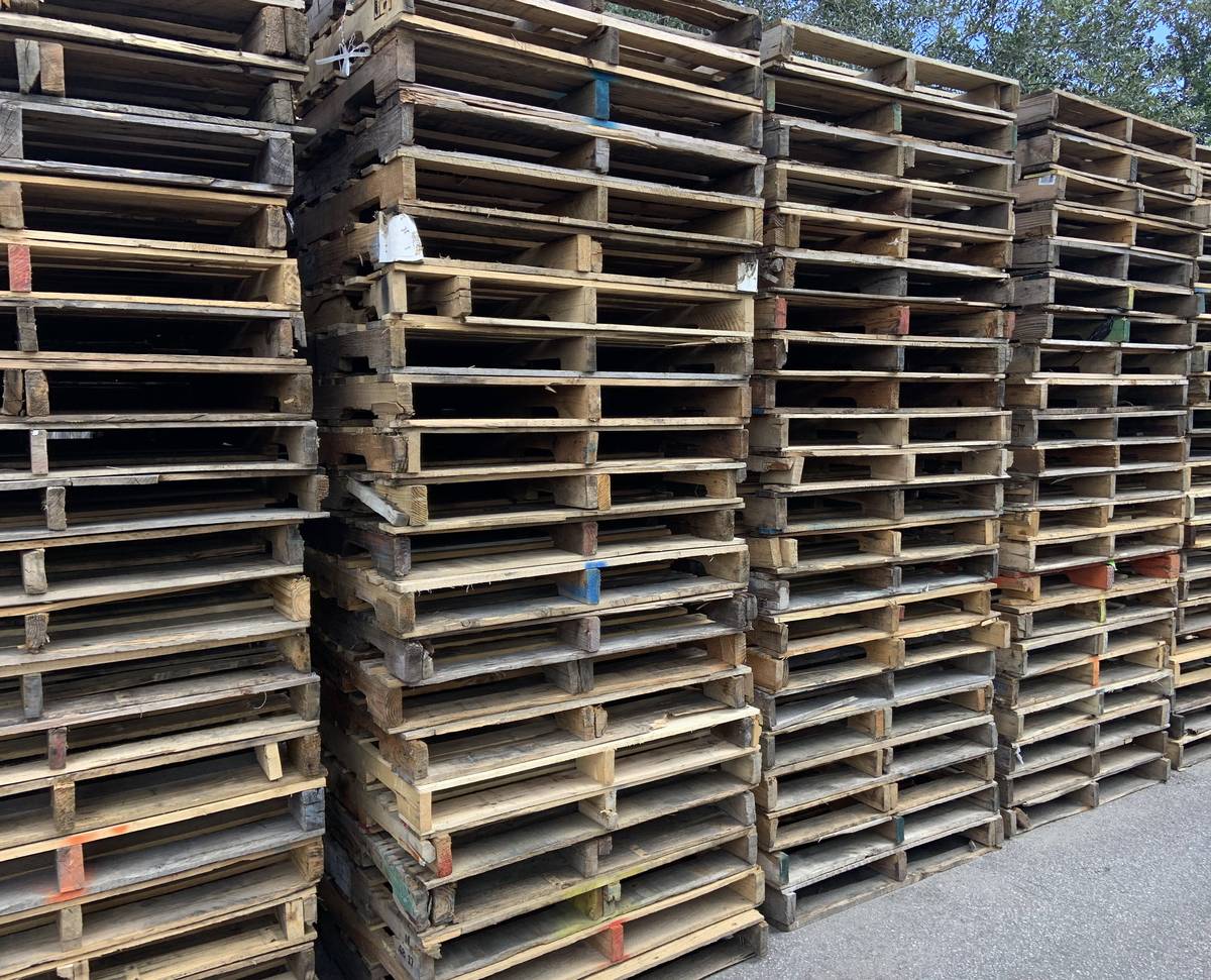 Recycled wood pallets stacked in rows at Florida outdoor supply yard