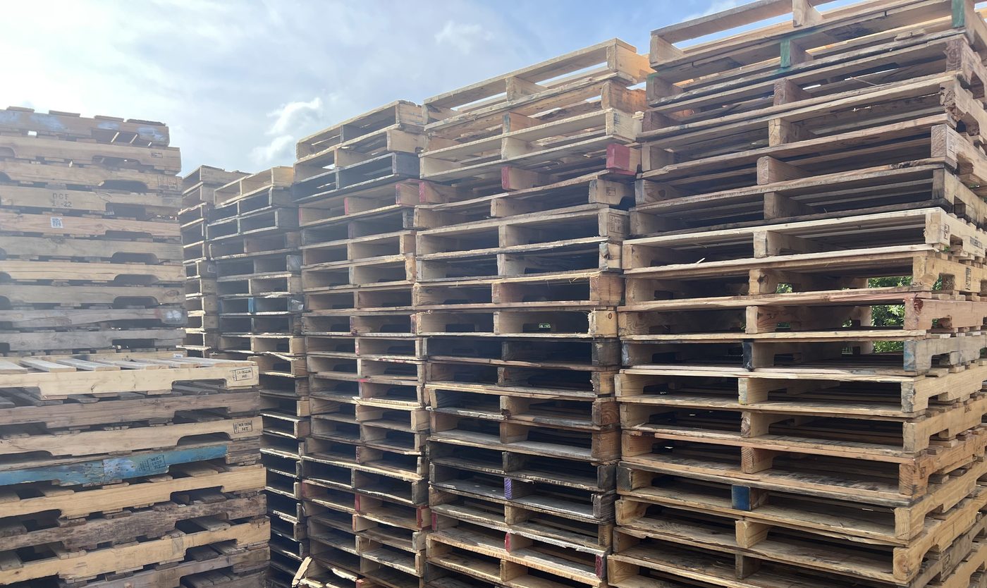 Recycled pallets stored outdoors at Florida pallet yard - humidity storage example